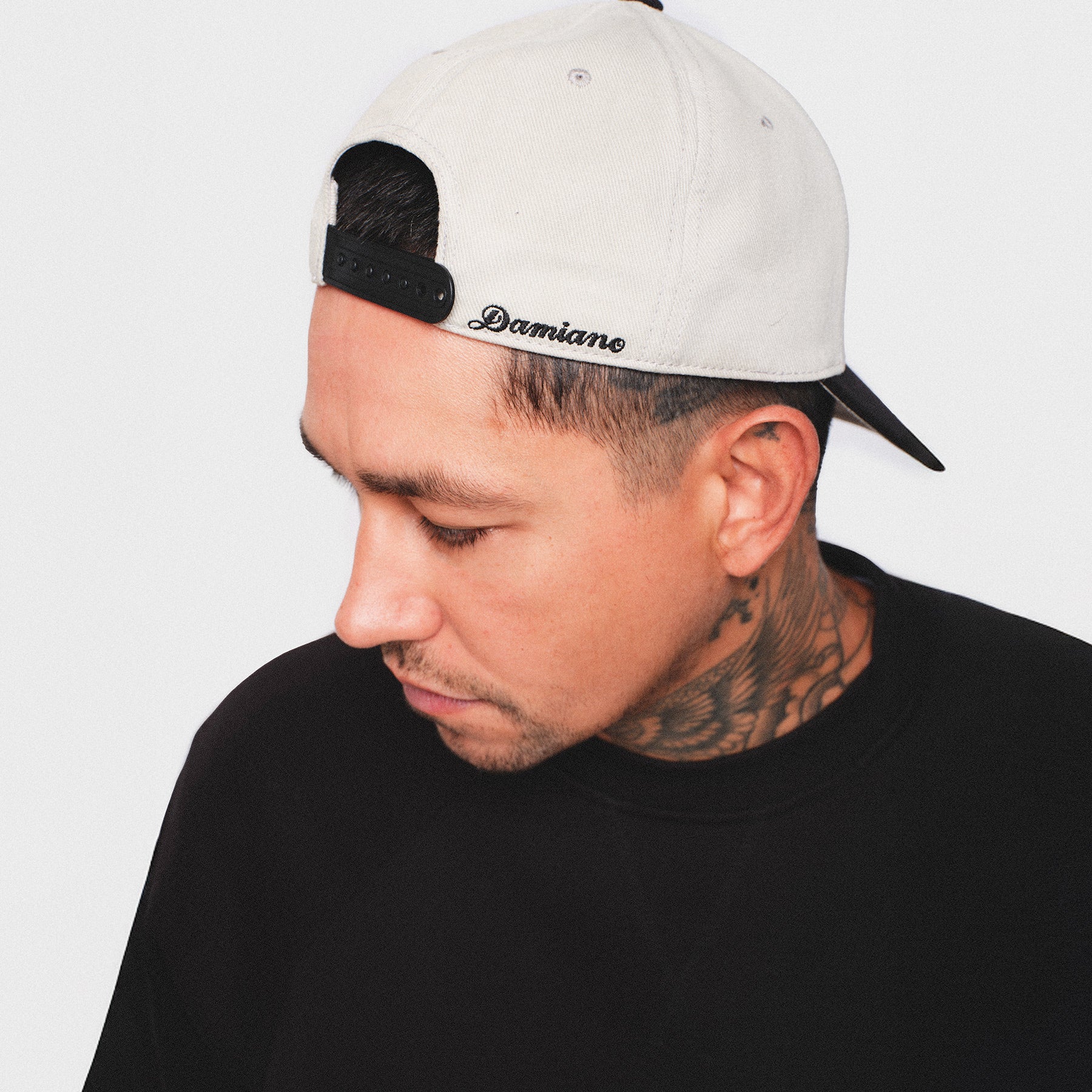 Putty light gray bone white black baseball cap hat SnapBack Damiano embroidered logo high quality clothing luxury streetwear New York City man model tattoos smith street Brooklyn