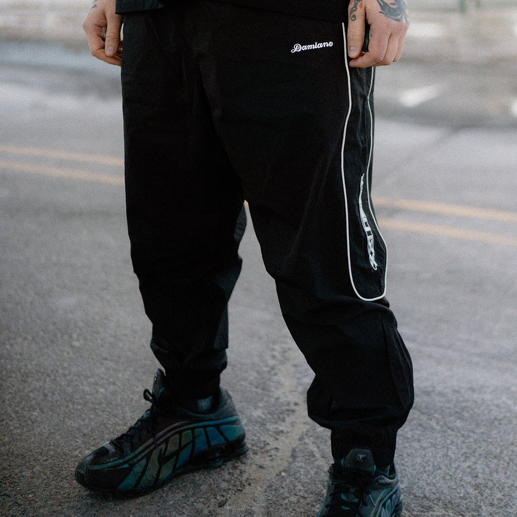 man model tattoos black track pants reflective streetwear hip hop hardcore damiano clothing xxl heat 1000words forever nike