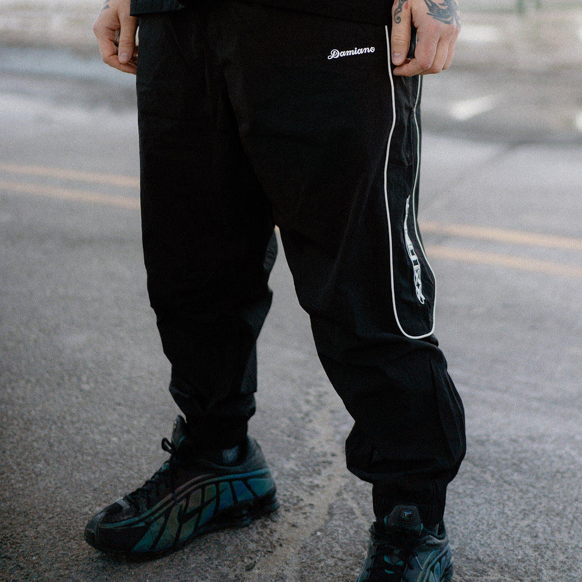 man model tattoos black track pants reflective streetwear hip hop hardcore damiano clothing xxl heat 1000words forever nike