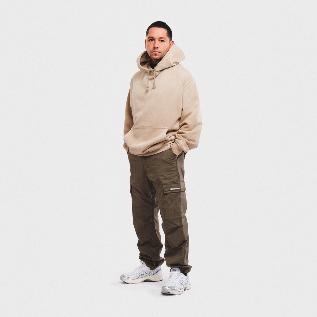 Vintage enzyme mineral wash cream beige tan light brown hoodie sweatshirt sweats high quality cotton men’s luxury streetwear fashion style Damiano clothing oversized Cargo pants man model tattoo smith street Brooklyn New York city