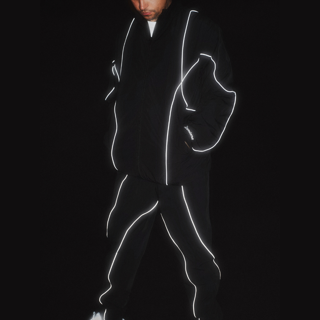 man model tattoos black track jacket pants tracksuit 3M reflective luxury streetwear damiano clothing new york city